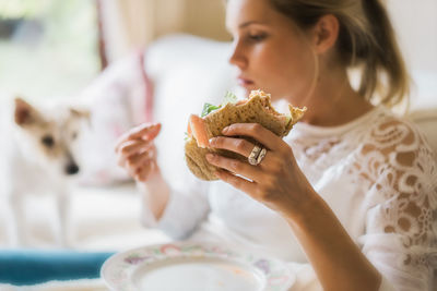Close-up of woman eating food at home