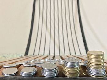 Close-up of coins stacked on table