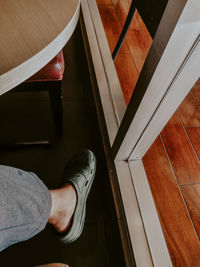 Low section of man standing on tiled floor