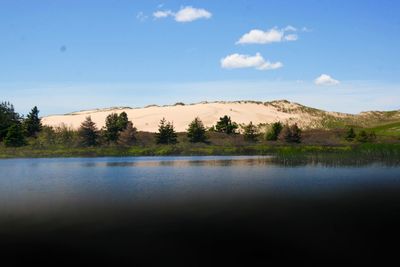Scenic view of calm lake against sky
