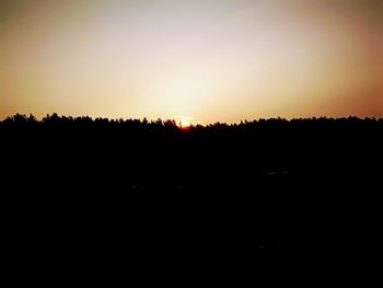 Scenic view of silhouette landscape against clear sky during sunset