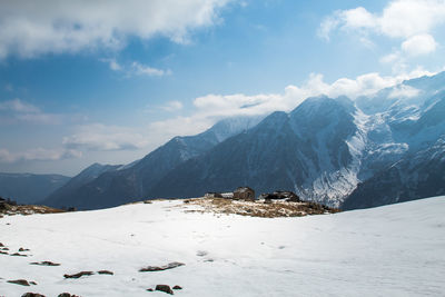 Scenic view of snow covered mountains against sky