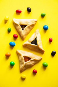 High angle view of cookies on yellow background