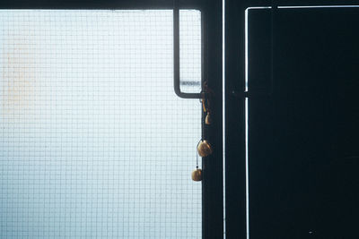 A bell hanging on a door handle.