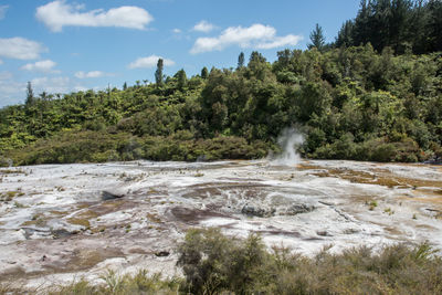 Scenic view of waterfall against sky