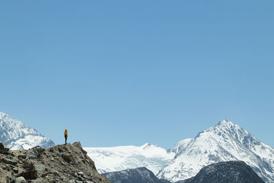 Scenic view of snowcapped mountains against clear blue sky