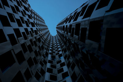 Low angle view of modern buildings against clear sky at dusk