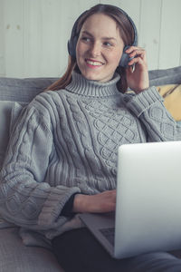 Portrait of a smiling young woman using mobile phone