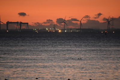 Scenic view of sea against orange sky