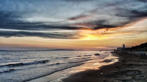 Scenic view of beach against sky during sunset