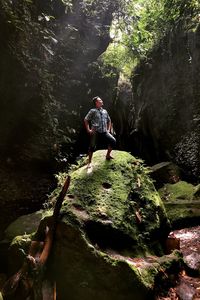 Man on rock in forest