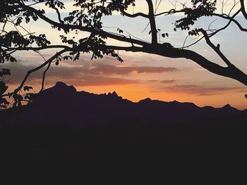 Scenic view of silhouette mountains against sky at sunset