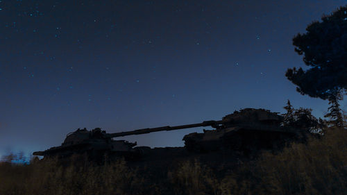 Low angle view of abandoned building against sky at night