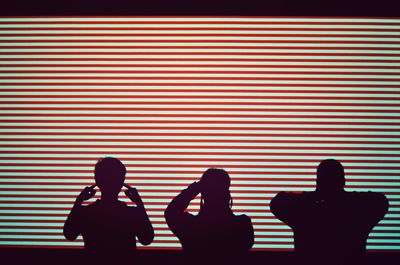 Silhouette people covering eyes ears and mouth