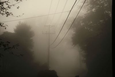 Low angle view of electricity pylon against sky