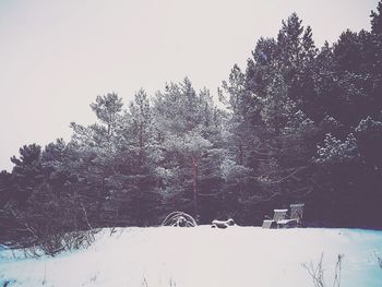 Snow covered field against clear sky