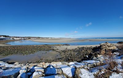 Scenic view of sea against blue sky