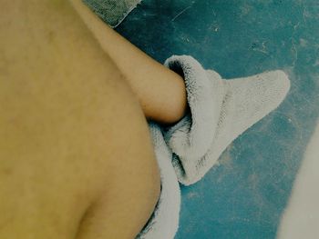 Low section of woman relaxing on floor