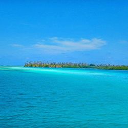 Scenic view of sea against blue sky