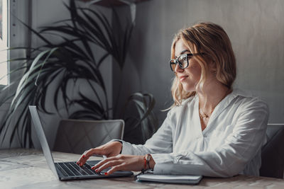 Young woman using laptop at home