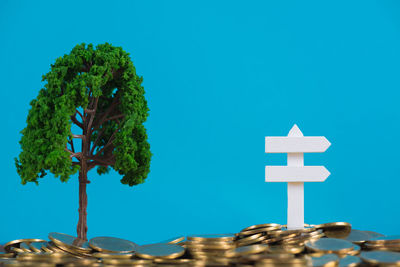 Low angle view of coin against blue sky