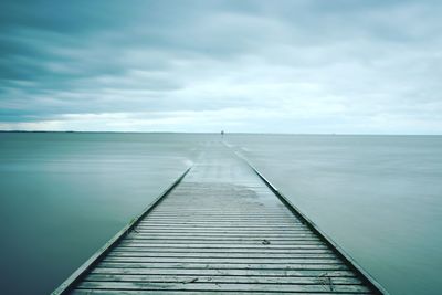 Pier over sea against sky