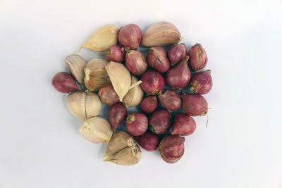 High angle view of fruits in plate against white background