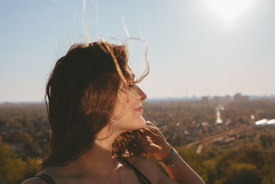 Portrait of beautiful woman against sky