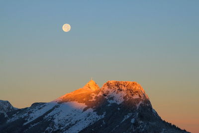 Scenic view of snowcapped mountains against sky during sunset