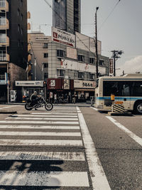 Vehicles on road against buildings in city