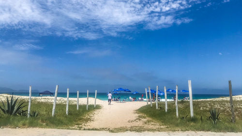 Scenic view of beach against blue sky