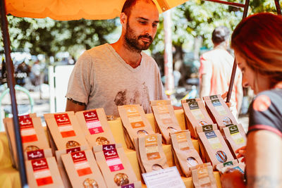 Young couple for sale at market stall