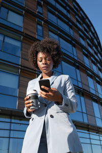 African american entrepreneur browsing cellphone
