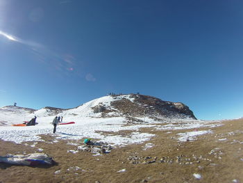 Low angle view of beach against blue sky