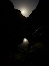 Scenic view of silhouette mountains against sky at night