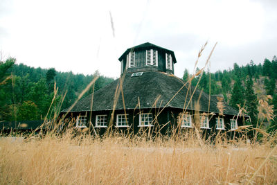 Built structure on field against sky