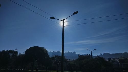 Low angle view of street lights against sky