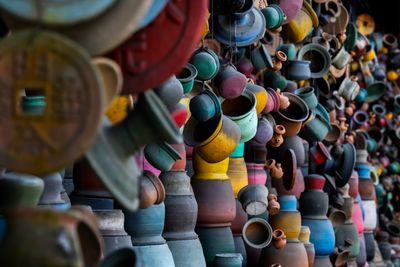 Multi colored pots for sale at market stall