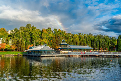 A view of a rainbow over trees at gene coulon park in renton, washington.