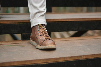 Low section of man standing on seat