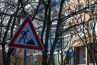 Road sign against trees