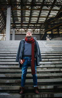 Portrait of man standing on staircase