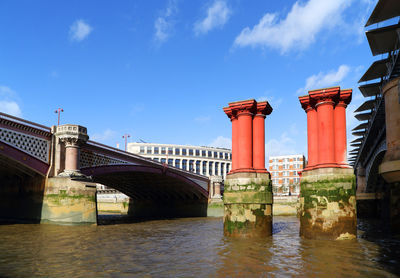 View of thames river against cloudy sky