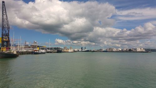 Panoramic view of sea and cityscape against sky
