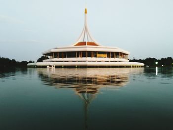 Pavilion reflecting on calm lake at suan luang rama ix