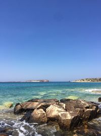 Scenic view of sea against blue sky