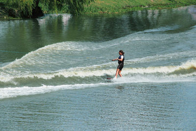 Full length of man surfing in sea