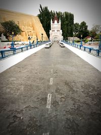 Road leading towards temple against clear sky