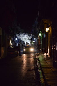 Illuminated street lights in city at night