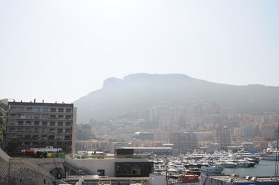 Buildings in city against clear sky